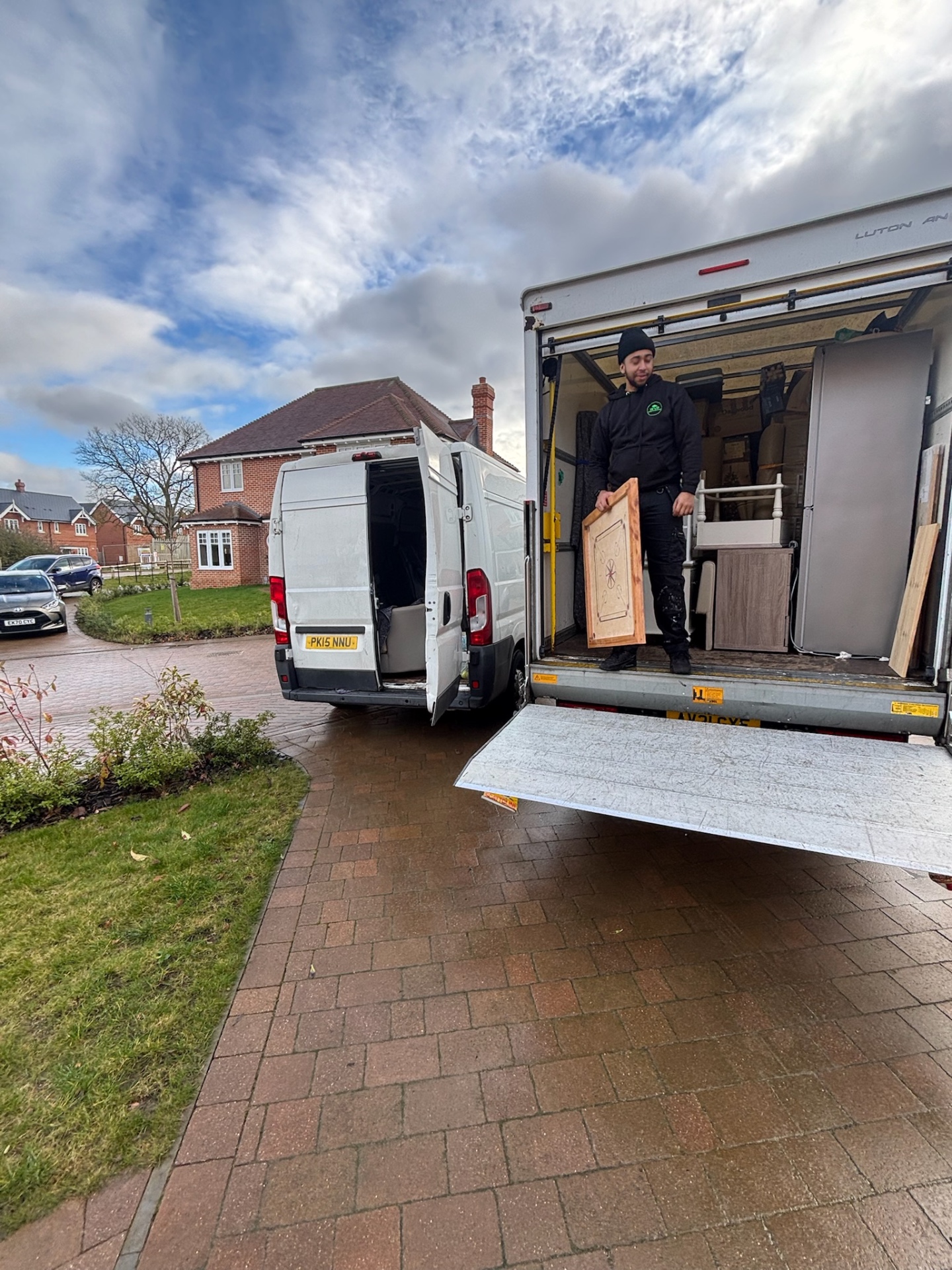 WVR crew unloading furniture from a Luton tail-lift van on a Colchester driveway